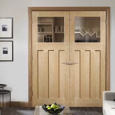 a living room filled with furniture and wooden doors