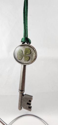 This listing is for one Genuine "Lucky" Four-Leaf Clover preserved in two-part epoxy resin on an antique silver color metal pendant. Clover is set in clear resin, green silk cord included for hanging, limit exposure to direct sunlight.  Item pictured is the one-of-a-kind wild, hand picked by me, trifolium repens clover you will receive.  *All clovers are wild grown, found in my backyard. I use high quality, non-yellowing, artisan grade two-part epoxy resin. Due to the natural qualities of both p Key Ornament, Skeleton Key, Four Leaves, Lucky Clover, Silk Cord, Clear Resin, Green Silk, Metal Pendant, Four Leaf Clover