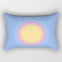 a blue rectangular pillow with the words gemini on it and an orange circle