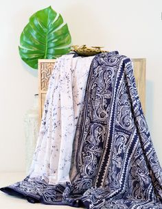 Experience the beauty and tradition of Mulmul Batik Kantha! This unique piece is handcrafted with intricate batik designs and delicate kantha embroidery. Add a touch of culture and elegance to your home with this one-of-a-kind piece. Perfect for decorating or gifting to someone special. Bohemian Indigo Batik Print Dupatta, Bohemian Indigo Dupatta With Batik Print, Traditional Batik Print Dupatta For Festival, Bohemian White Dupatta With Printed Motifs, Bohemian Cotton Patterned Sarong, Bohemian Patterned Cotton Sarong, Blue Bohemian Sarong With Traditional Patterns, Bohemian Indigo Bandhani Print Dupatta, Bohemian Indigo Bandhani Dupatta