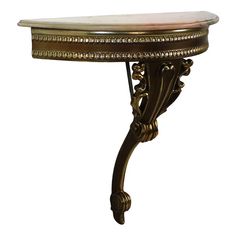 an ornately decorated table with marble top