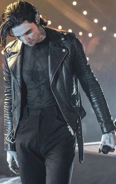 a male in a black leather jacket and pants