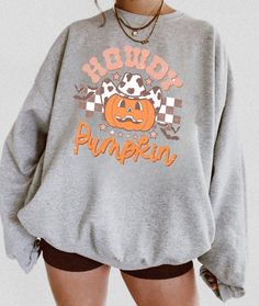 Halloween sweatshirt that will make you cozy during the spookiest time of the year! The perfect sweatshirt to cuddle up in at home, or super stylish to wear out to show your holiday spirit! PRODUCT INFORMATION * High-quality materials for the perfect cozy hoodie * Direct-to-garment printing, No cracking! * This sweatshirt runs true to size for a perfect unisex fit, please check size chart * The fabric is made from 50% cotton and 50% polyester * True to size sweatshirts, please size up for an ove