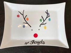 a white plate with reindeer's face drawn on it and the words new holidays written in black