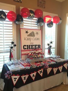 a table topped with lots of desserts and balloons in front of a sign that says keep calm and cheer