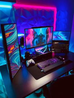 a computer desk with two monitors and a keyboard on it in front of a neon colored wall