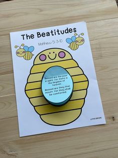 the beetitues activity book is displayed on a wooden surface with a clipping