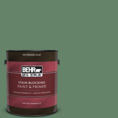 a green paint can with the words behr ultra stain - blocking paint and primer in