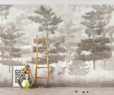 a room with a ladder and wallpaper that has trees on it