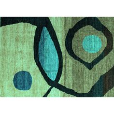 an abstract rug with blue and green circles on it's surface, in the middle of which is a circular design