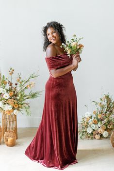 a woman in a red dress holding flowers