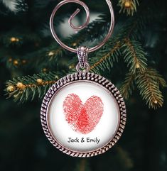 a christmas ornament with a fingerprint in the shape of a heart on it