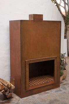 an outdoor fireplace made out of wood and metal