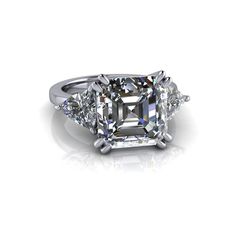 10mm, 4.75 ct asscher cut Colorless Moissanite, DEF Color, VVS Clarity. (2) 6mm, .60 ct asscher cut colorless moissanite DEF Color, VVS Clarity.*Band width: 2.8mm*5.95 carat total weight.*Your moissanite stone purchase will arrive with a warranty card/certificate of authenticity. Online registration is recommended.*The ring is custom made just for you in your ring size and metal preference. It is offered in solid gold, and solid platinum. Other metals are available upon request.*Please contact u Formal Asscher Cut Lab Grown Diamond Ring, Formal Asscher Cut Lab-grown Diamond Ring, Timeless Three Stone Asscher Cut Jewelry, Formal Three Stone Trillion Cut Jewelry, Formal Trillion Cut Three Stone Jewelry, Formal Three-stone Trillion Cut Jewelry, Asscher Cut Three Stone Anniversary Ring, Trillion Cut Moissanite Diamond Ring Fine Jewelry, Three Stone Diamond Ring, Octagon Shaped