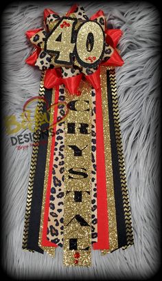 a red and black ribbon with the number forty on it, sitting on top of a fur