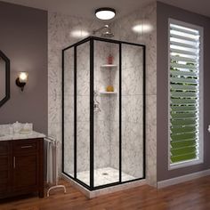 a bathroom with a walk in shower next to a sink and mirror on the wall