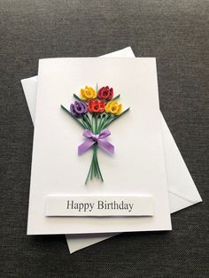 a birthday card with flowers on it and the words happy birthday written in white paper