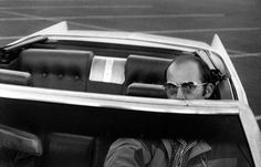 a man sitting in the back seat of a car