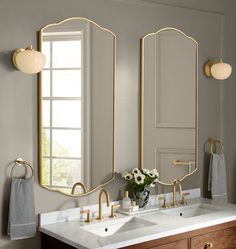 a bathroom with two sinks and mirrors on the wall