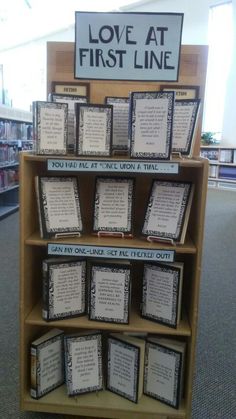 a book shelf that has some kind of sign on it in the middle of a library