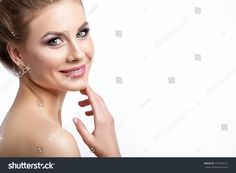 a beautiful woman posing for the camera with her hand on her chin and looking at the camera