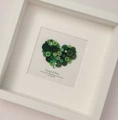 a white frame with buttons in the shape of a heart