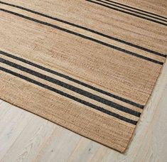 an area rug with black and beige stripes