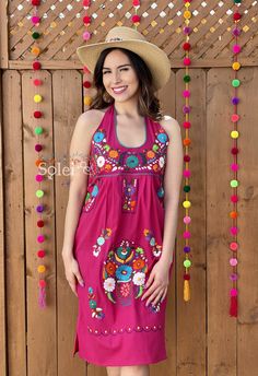 This Beautiful Halter Dress boasts a Traditional Mexican floral design combined with a modern style dress. It's made out of fine Mexican cotton, has ties around the neck and has elastic on the back for a tighter fit. It has hand embroidered flowers and hand knit details throughout. This dress is handmade by Mexican Artisans in Mexico. Note: Since this dress is Hand embroidered the embroidered colors on each dress vary, making them one of a kind. Summer Embroidered Halter Neck Dress, Embroidered Halter Neck Summer Dress, Embroidered Halter Neck Dress For Summer, Pink Fitted Sleeveless Embroidered Dress, Summer Floral Embroidered Halter Neck Dress, Floral Embroidered Halter Neck Beach Dress, Beach Dresses With Floral Embroidery And Halter Neck, Summer Halter Neck Dresses With Floral Embroidery, Pink Sleeveless Embroidered Summer Dress