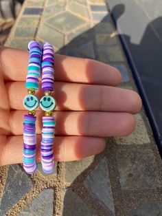 This is a super cute and preppy clay bead bracelet. It is made with stretchy clear string, clay beads, and a teal smile bead. This is handmade with love and care while making it. When you are ordering you can DM me for the size, and if you want to make any changes, free of charge. I also do bulk orders. Thank you for shopping with blessingsboutique. Have a Good Day!! Cute Heishi Beads Friendship Bracelets, Beach Jewelry With Smiley Face Round Beads, Fun Round Heishi Beads Jewelry, Playful Heishi Beads Stretch Bracelet, Playful Smiley Face Jewelry For Beach, Coconut Girl Jewelry, Preppy Clay Bead Bracelets, Smiley Face Jewelry, Jewelry Preppy