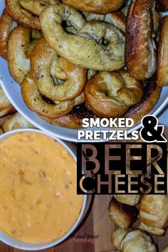 some pretzels and beer cheese are on a plate next to the bowl with dip