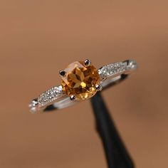 It is a natural citrine ring. The main stone is 7mm*7mm round cut, weight about 1.40 carats.The basic metal is sterling silver and plated with rhodium.To change the metal to a solid gold (white/rose) or platinum is also available, please ask for a quotation if you want.You can also go to my shop Home for more elegant rings: https://www.etsy.com/shop/godjewelry?ref=hdr_shop_menuPeridot is August birthstoneCustomization is always welcome and please feel free to contact with me if you have any desi Amber Engagement Ring, Yellow Stone Ring, Yellow Stone Rings, Elegant Rings, November Birthstone Ring, Blue Topaz Engagement Ring, Emerald Wedding Rings, Green Amethyst Ring, Yellow Engagement Rings