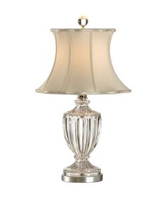 a table lamp with a white shade on it's base and gold trimming