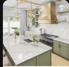 a large kitchen with marble counter tops and green cabinetry, along with an island in the middle