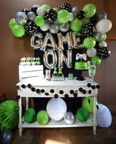 a table with balloons and decorations on it