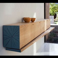 two bowls sit on top of a wooden shelf