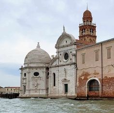 an old building sitting in the middle of water