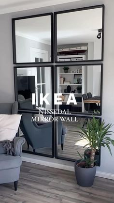 a living room filled with furniture and windows reflecting the inside of it's home