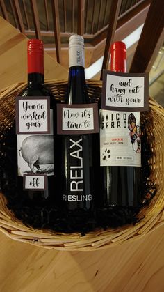 three bottles of wine sitting in a basket