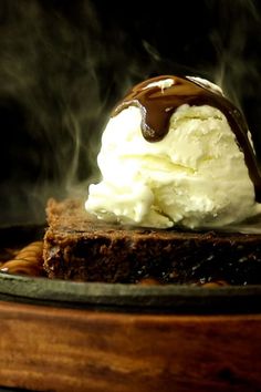 a piece of cake with ice cream and chocolate sauce