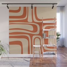 an orange and white wall mural in a living room with wooden flooring, bookshelves