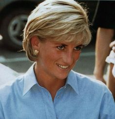 the prince and princess of wales smile as they pose for a photo in their official blue shirt