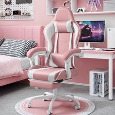 a pink and white office chair sitting in front of a bed