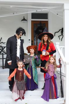 a group of people in costumes standing on steps