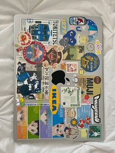 an apple computer with many stickers on it