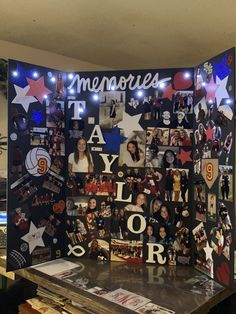 a table topped with pictures and lights next to a wall covered in photos that spell out memories