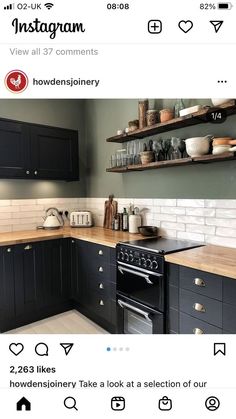 a kitchen with black cabinets and white subway backsplash