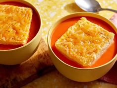 two bowls filled with soup on top of a table