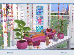 the room is decorated with colorful beads and potted plants