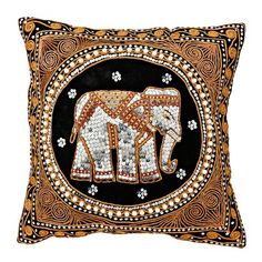 an intricately decorated pillow with two elephants on the front and side, in gold and black