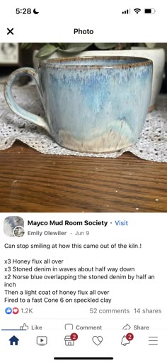 a blue cup sitting on top of a wooden table